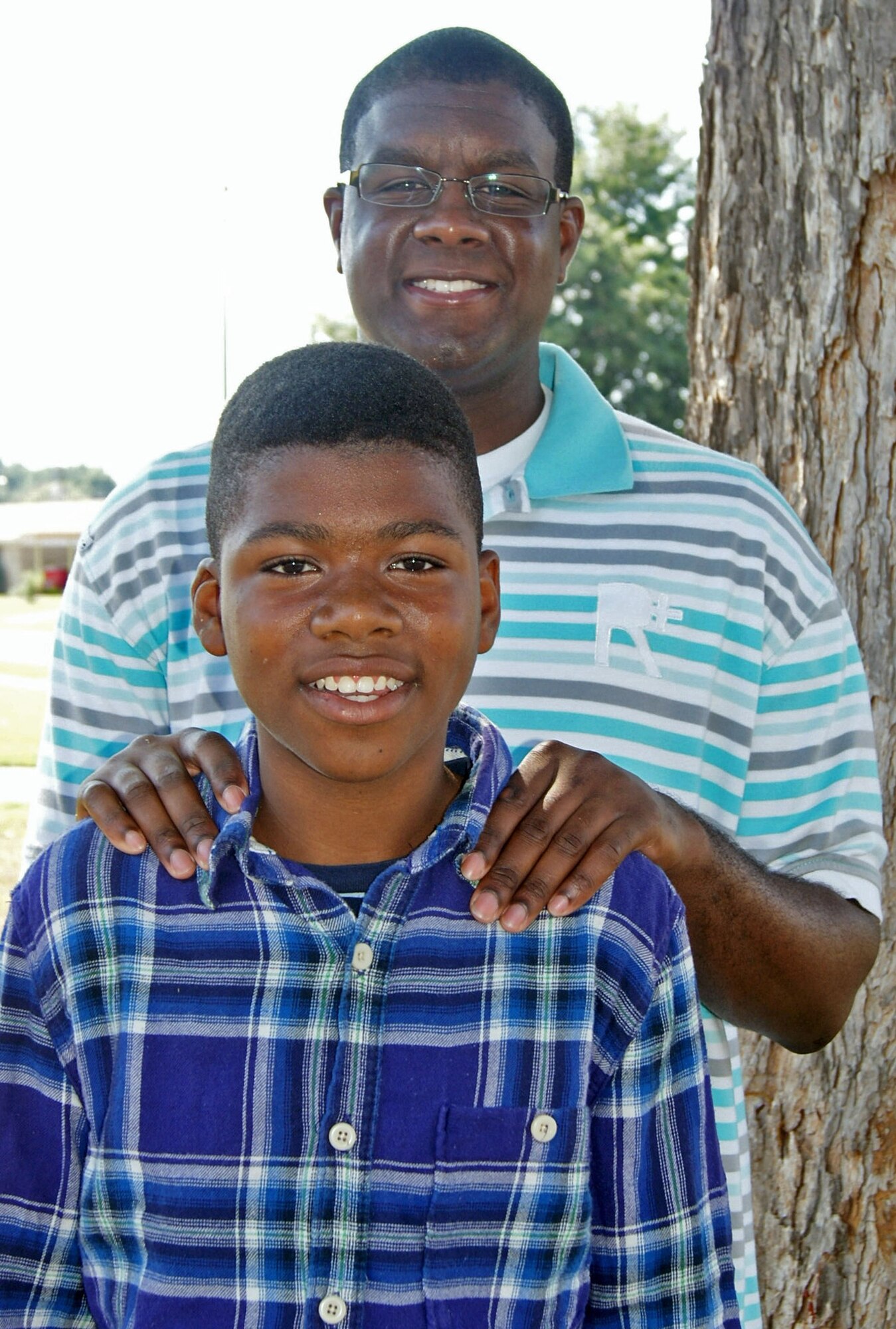 Staff Sgt. Jason Greenwell, 372nd Training Squadron Field Training Detachment, poses with mentee, 13-year-old La'Torri Simmons. Greenwell has volunteered as Simmons' mentor for the past four years as part of the Lighthouse after-school program. (Courtesy Photo)

