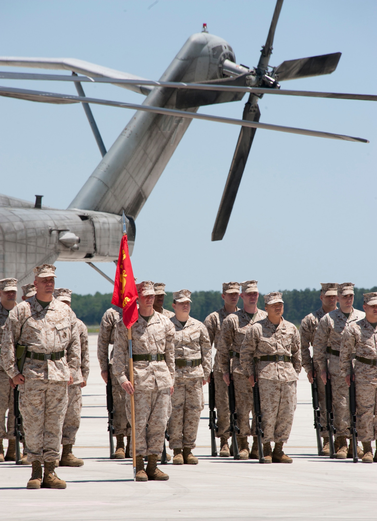 Marines stand at attention in formation as Marine Aircraft Group 49 Commanding Officer, Col. Christopher J. Papaj, relinquished command to Col. Robert T. Tobin III June 16 here. The change of command ceremony took place on the tarmac in front of the Marines’ aircraft hangar against a backdrop of several aircraft and ground-support vehicles. Papaj hails from Glendale, Calif. (U.S. Air Force photo by Master Sgt. Denise Johnson/Released)