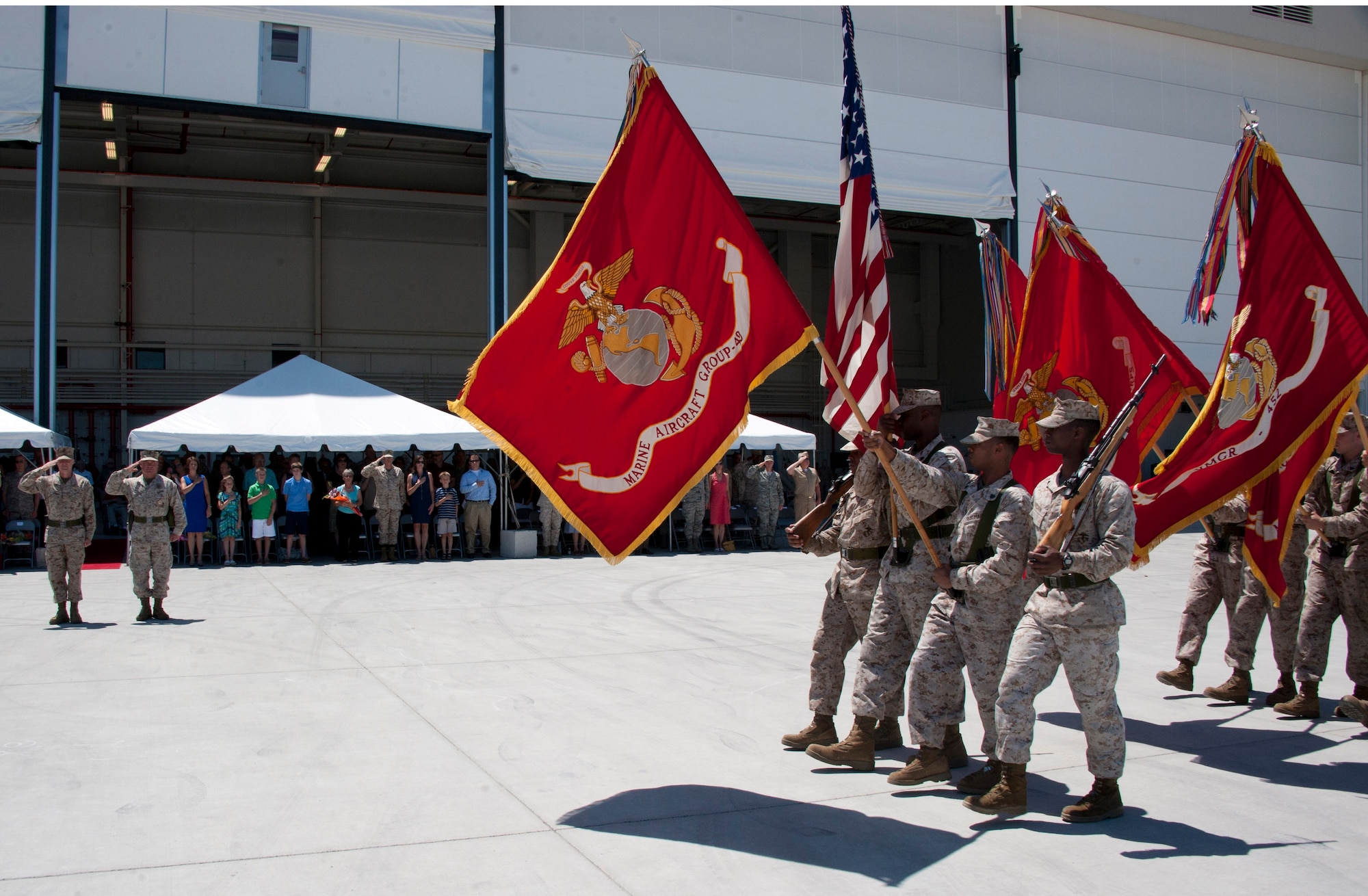 (Far left) Col. Robert T. Tobin III, Marine Aircraft Group 49’s newly-appointed commanding officer, and Col. Christopher J. Papaj, outgoing commanding officer, salute the Marine Forces Reserve Band New Orleans as the band paraded in front of attendees at a change of command ceremony here June 16. The change of command ceremony took place on the tarmac in front of the Marines’ aircraft hangar against a backdrop of several aircraft and ground-support vehicles. Tobin hails from Lake Havasu City, Ariz. (U.S. Air Force photo by Master Sgt. Denise Johnson/Released)