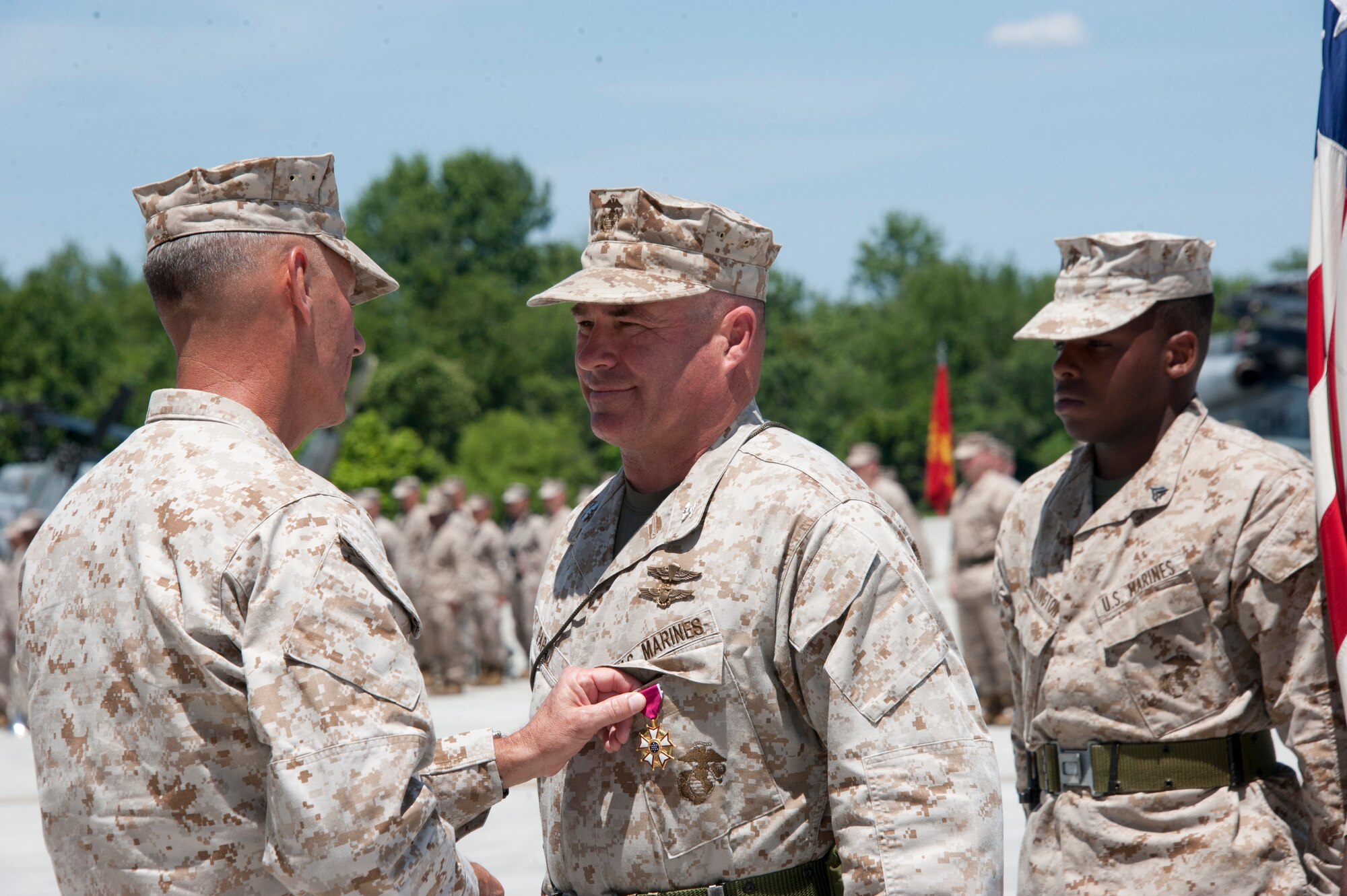 Commanding General of 4th Marine Aircraft Wing, Maj. Gen. Rex C. McMillian, pins the Legion of Merit on Col. Christopher J. Papaj during a change of command ceremony here June 16. Papaj, who hails from Glendale, Calif., relinquished command of Marine Aircraft Group 49 to Col. Robert T. Tobin III. Tobin hails from Lake Havasu City, Ariz. (U.S. Air Force photo by Master Sgt. Denise Johnson/Released)
