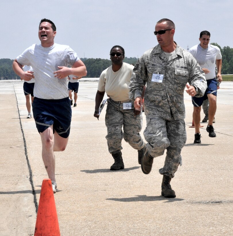 Staff Sgt. Jake Logue of the 35th Aerial Port Squadron, Joint Base McGuire-Dix, N.J., gets encouragement from Master Sgt. Josh Bell as he finishes the tough Fit to Fight portion of the Air Force Reserve’s 2012 Port Dawg Challenge, going on this week at Dobbins Air Reserve Base, Ga. (Air Force photo/Master Sgt. Chris Durney)
