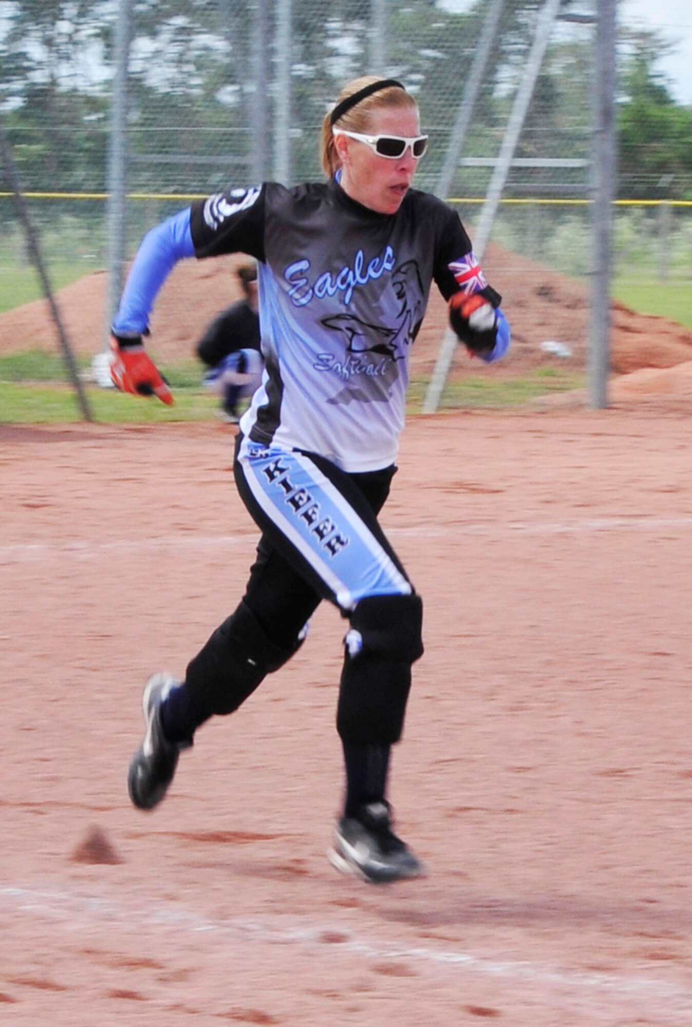 ROYAL AIR FORCE LAKENHEATH, England – Tiffany Kiefer, Lakenheath Lady Eagles Varsity team member, runs to first base during the first RAF Lakenheath Invitiational at the softball fields June 17, 2012. Men’s and women’s softball teams from U.S. bases throughout the U.K. and Germany came out to compete June 16 and 17. The Spangdahlem Air Base women’s team took first place for their bracket.  (U.S. Air Force photo by Senior Airman Tiffany M. Deuel)  