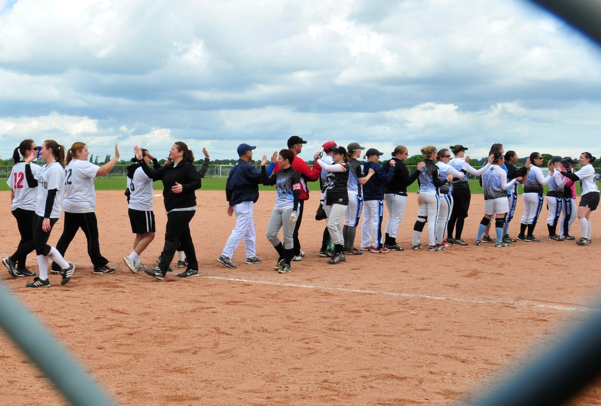ROYAL AIR FORCE LAKENHEATH, England – Members of the RAF Lakenheath and U.S. Army Garrison Bamberg, Germany women’s softball teams form lines to high-five each other after a game during the first RAF Lakenheath Invitational at the softball fields June 17, 2012. Men and women’s softball teams from U.S.  bases throughout the U.K. and Germany came out to compete June 16 and 17. The Spangdahlem Air Base women’s team took first place for the women’s bracket. (U.S. Air Force photo by Senior Airman Tiffany M. Deuel)