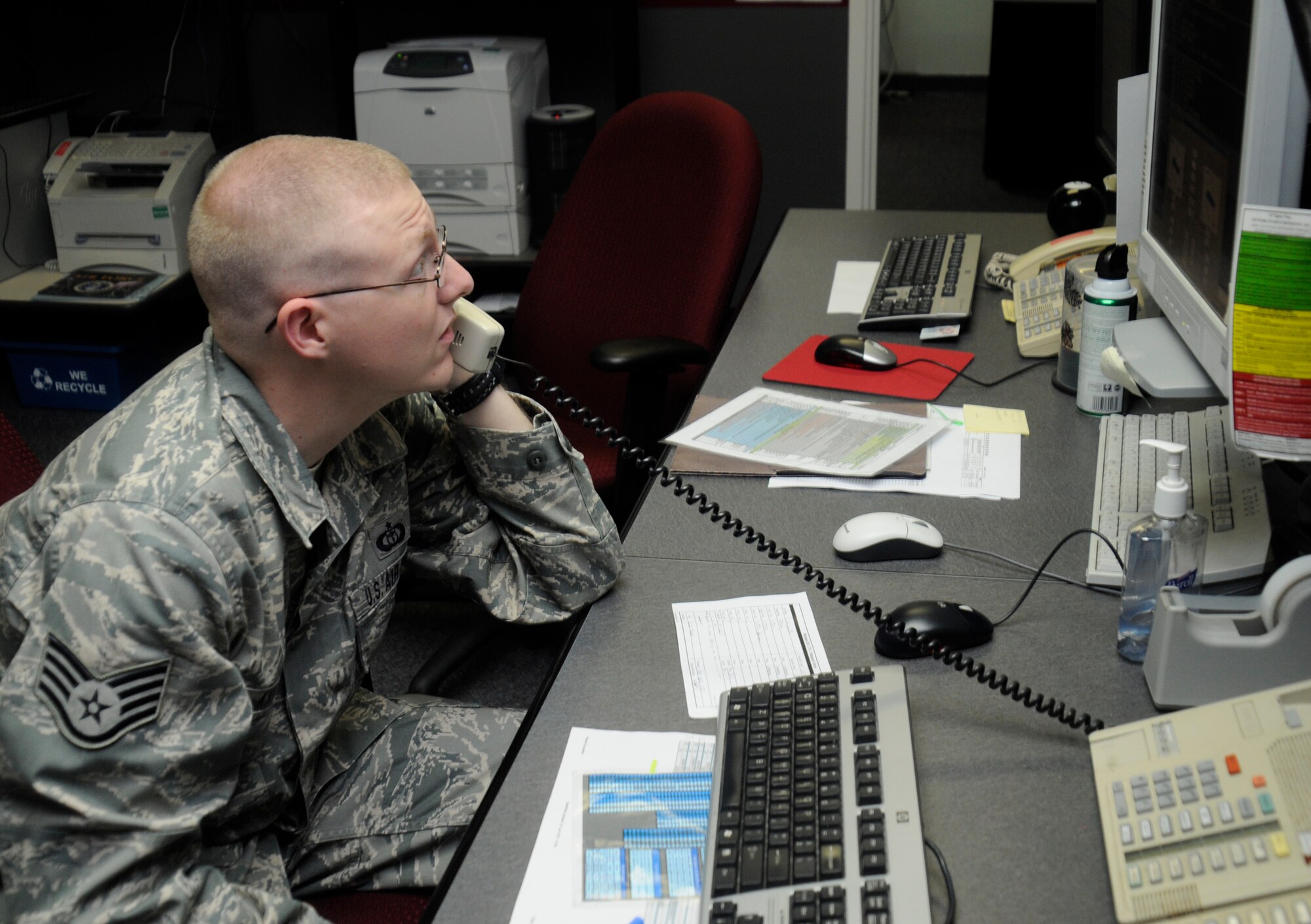 U.S. Air Force Staff Sgt. Brandon Knight, 35th Operations Support Squadron weather flight forecaster, speaks with the supervisor of flying at Misawa Air Base, Japan, June 21, 2012. The SOF is a designated pilot who passes on weather information to other pilots. The SOF receives information from the weather forecasters when there are weather changes or when conditions are not suitable to fly in. (U.S. Air Force photo by Airman 1st Class Zachary Kee/Released) 