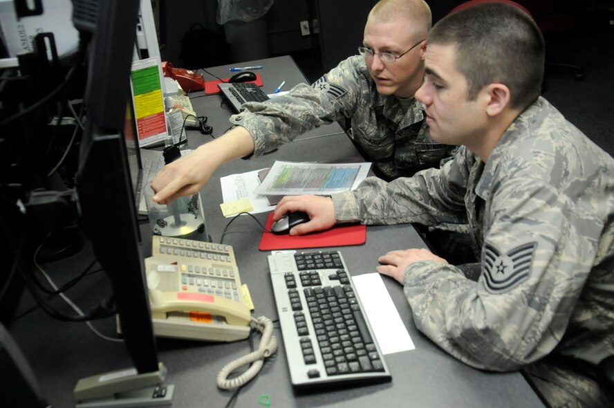 U.S. Air Force Tech Sgt. Steve Fanis, right, and Staff Sgt. Brandon Knight, 35th Operations Support Squadron weather flight forecasters, look at screens and radars at Misawa Air Base, Japan, June 21, 2012. The radar capabilities range from displaying lightning within five miles, precipitation and the temperature in the air. Weather conditions are a key factor in determining whether pilots can fly or not. (U.S. Air Force photo by Airman 1st Class Zachary Kee/Released)