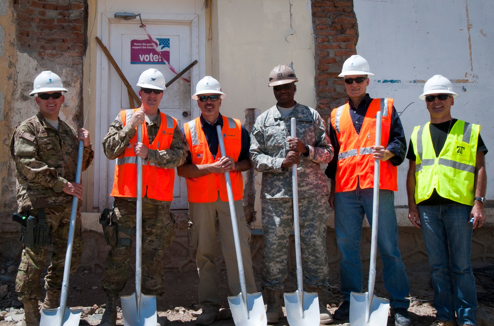 Leaders from the 455th Expeditionary Mission Support Group and construction contractors break ground at the future site of the new 455 EMSG headquarters building at Bagram Airfield, Afghanistan, June 20, 2012. When complete, EMSG leaders will oversee various mission support functions from the new building. (U.S. Air Force photo/Capt. Raymond Geoffroy)
