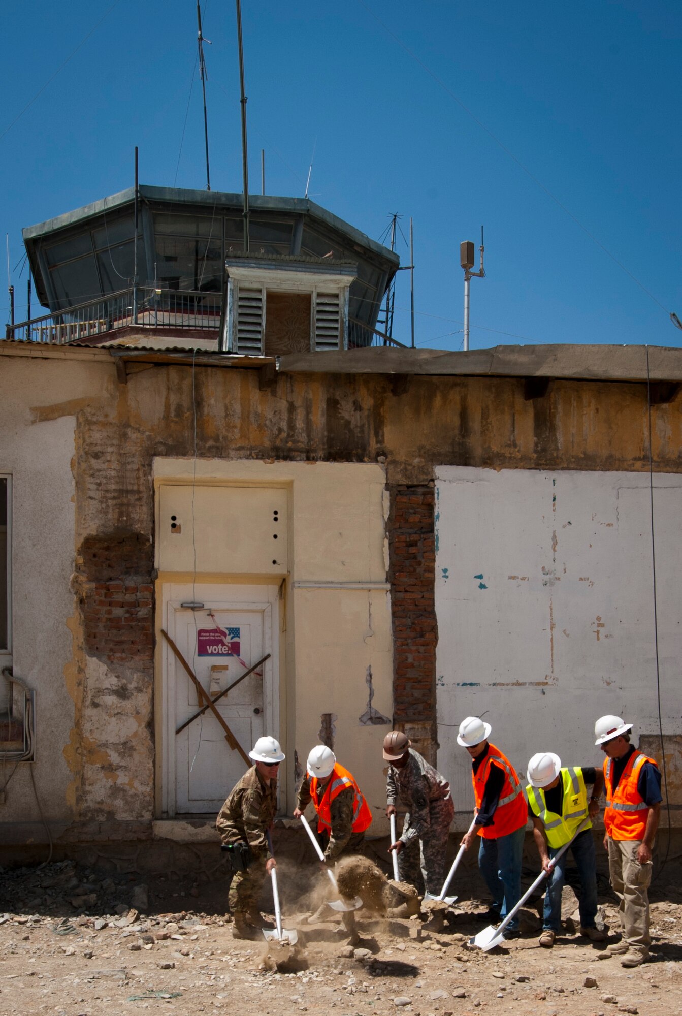 Leaders from the 455th Expeditionary Mission Support Group and construction contractors break ground at the future site of the new 455 EMSG headquarters building at Bagram Airfield, Afghanistan, June 20, 2012. When complete, EMSG leaders will oversee various mission support functions from the new building. (U.S. Air Force photo/Capt. Raymond Geoffroy)
