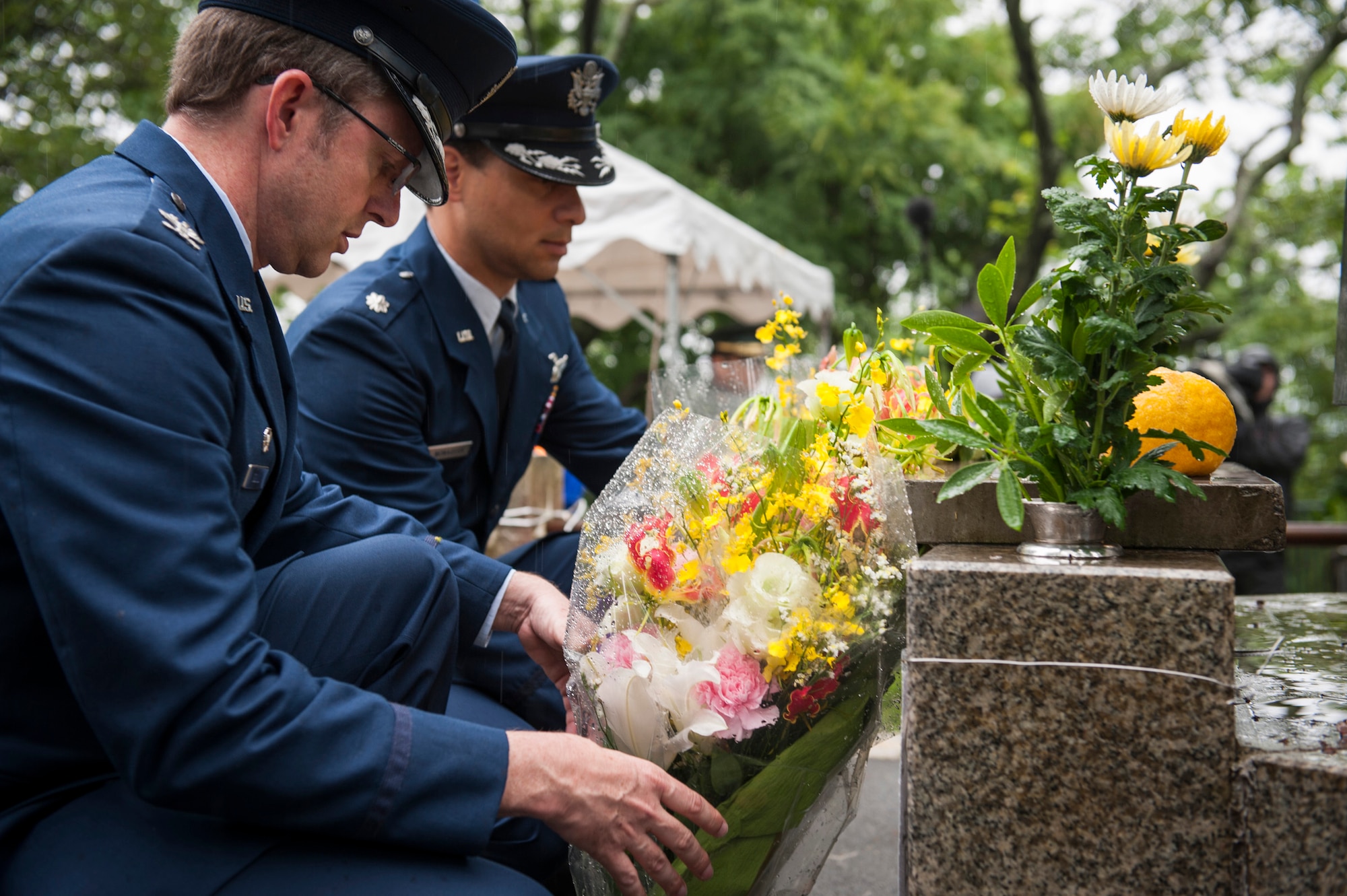 SHIZUOKA, Japan -- Col. David Gould II, left, 374th Operations Group commander, and Lt. Col. Dylan Monaghan, U.S. Embassy mutual defense assistance office Air Force programs officer, place flowers on the Japanese monument on Mount Shizuhata, Shizuoka, Japan, June 16, 2012. In mutual respect, Japanese officials placed flowers on the American monument there at the same time. (U.S. Air Force photo by Tech. Sgt. Samuel Morse)