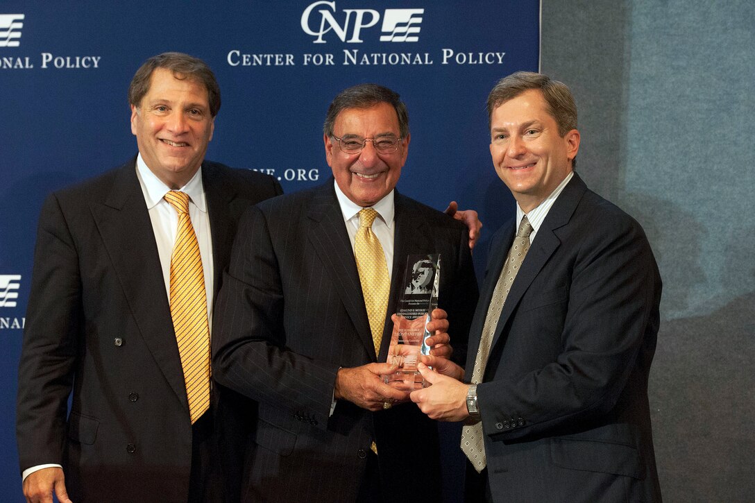 Defense Secretary Leon E. Panetta receives the Edmund S. Muskie Distinguished Public Service Award from Scott Bates, right, president of the Center for National Policy, and Peter Kovler, left, chairman, during the center's awards dinner at the National Press Club in Washington, D.C., June 21, 2012. The award honors Muskie, who died in 1996, for his service in the Navy, as governor of Maine, as U.S. senator and as U.S. secretary of state.