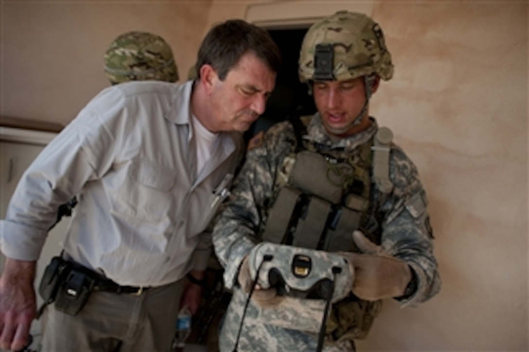 U.S. Army Sgt. Donald Armstrong explains a biometric scanning system to Deputy Secretary of Defense Ashton M. Carter during a counter Improvised Explosive Device training exercise, on Fort Campbell, Ky., on June 20, 2012.  Armstrong is assigned to the 101st Airborne Division.  