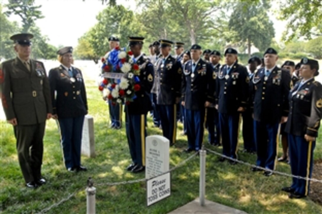 An honor guard soldier places a wreath next to the grave of Medal of Honor recipient Army Maj. Audie L. Murphy as Marine Corps Sgt. Maj. Bryan B. Battaglia, far left, senior enlisted advisor to the chairman of the Joint Chiefs of Staff, and the Military District of Washington chapter of the Sgt. Audie L. Murphy Club pay tribute to the World War II hero on his birthday at Arlington National Cemetery, Va., June 20, 2012. 