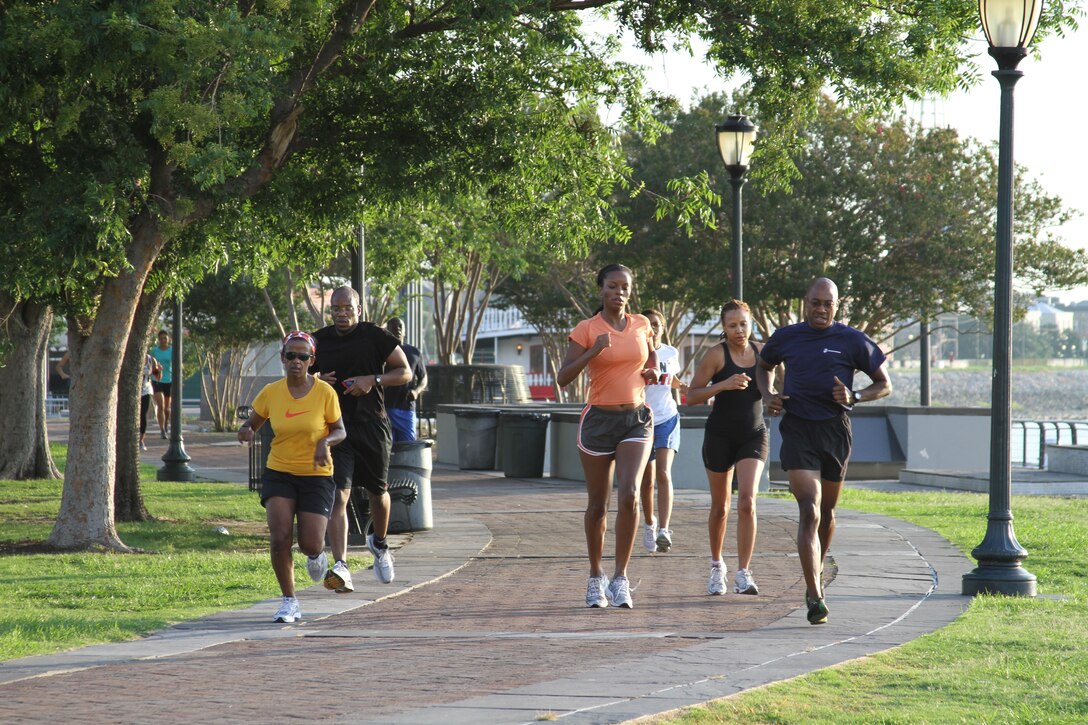 Major Michael Armistead (right) leads a group of journalists during their warm-up lap. Attendees of the National Association of Black Journalists convention got a chance to work out with the Marines June 21 and 22.::r::::n::::r::::n::::r::::n::