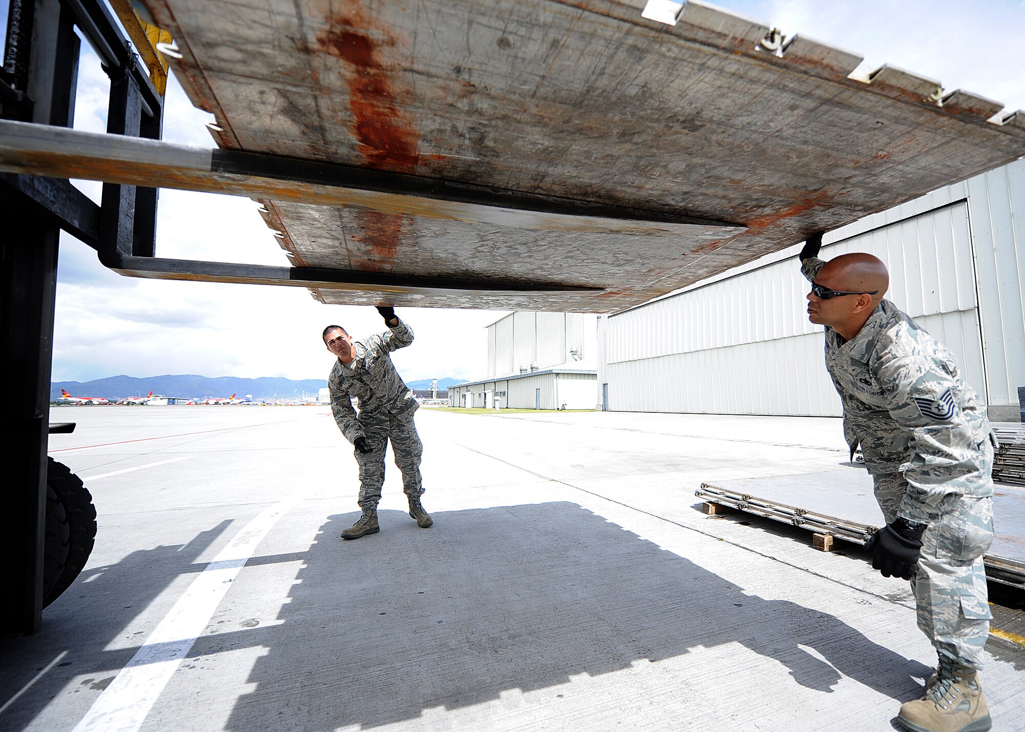 Staff Sgt. Peter Salinas, 571st Mobility Support Advisory Squadron aerial transportation air advisor, and Tech. Sgt. Luis Sanchez, 571st MSAS aircraft maintenance air advisor, and inspect pallet serviceability during an Air Mobility Command Building Partner Capacity mission June 21 at Commando Aéreo de Transporte Militar, Bogota, Colombia.  The 571st is participating in a month-long BPC mission with the Colombian air force to promote regional stability by fostering key relationships and enhancing partner nation capabilities.  The mission also supports the 12th Air Force’s (AFSOUTH) continued engagements in the U.S. Southern Command area of responsibility of Latin America and the Caribbean.  In addition, the 571st reached out to Inter-American Air Forces Academy and 12th AF (AFSOUTH) for assistance to complement their team. (U.S. Air Force photo by Tech. Sgt. Lesley Waters)
