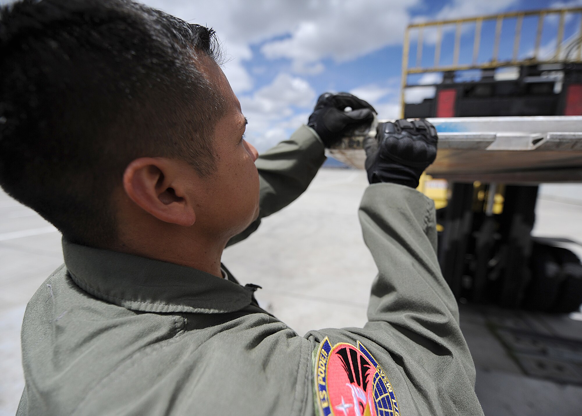 Staff Sgt. Javier Borges, 571st Mobility Support Advisory Squadron loadmaster air advisor, inspects pallet-ring serviceability during an Air Mobility Command Building Partner Capacity mission June 20 at Commando A?reo de Transporte Militar, Bogota, Colombia.  The goal of the MSAS deployment is to build lasting partnerships that can foster the bettering of both Air Forces, and in turn, provide a collaborative approach to regional challenges.  The mission also supports the 12th Air Force?s (AFSOUTH) continued engagements in the U.S. Southern Command area of responsibility of Latin America and the Caribbean.  (U.S. Air Force photo by Tech. Sgt. Lesley Waters)