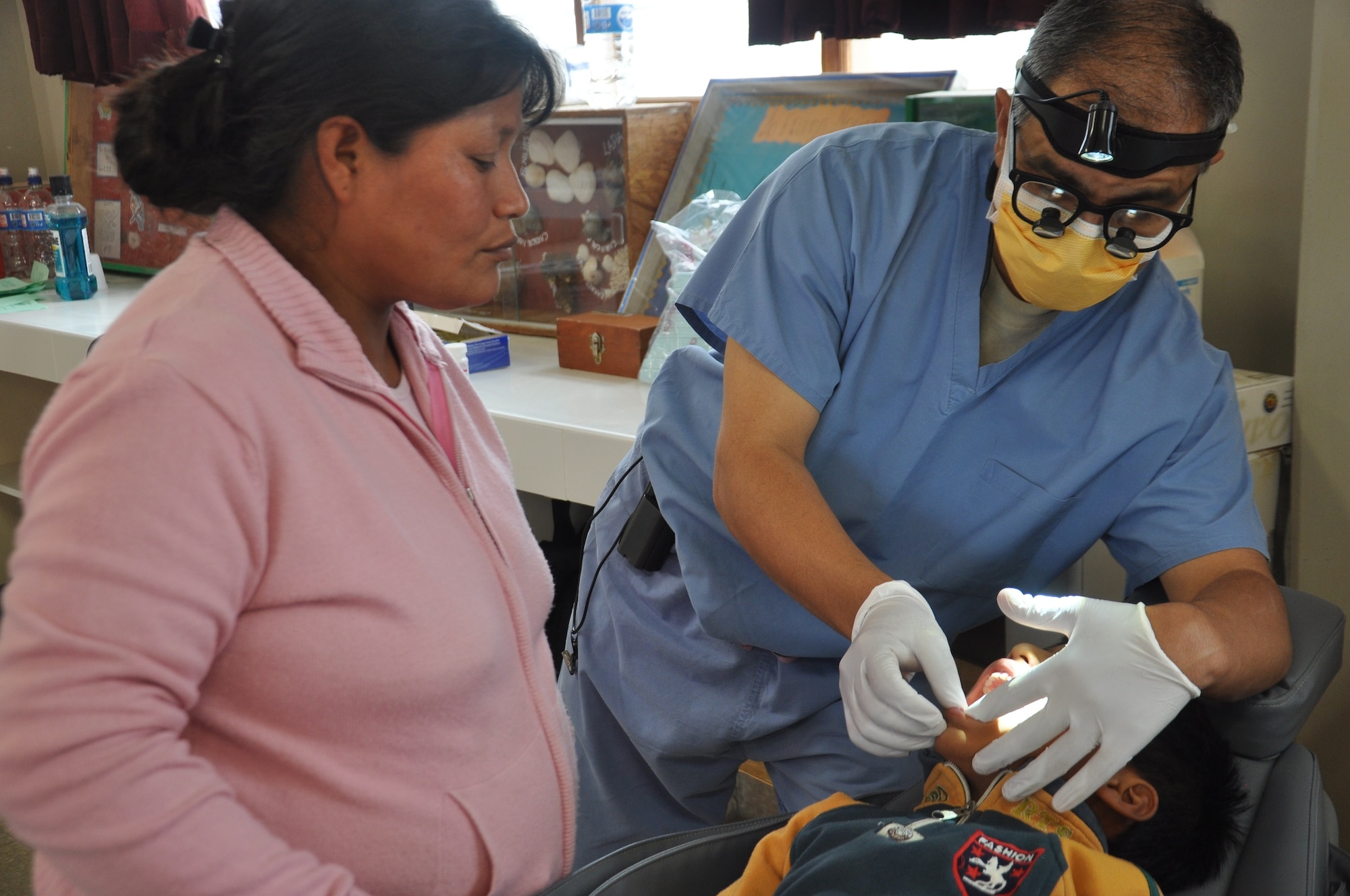 SAN CLEMENTE, Peru—Maj. Rene Saenz examines the teeth of a Peruvian boy while explaining his observations to the boy’s mother June 21. The medical care is being given as part of New Horizons, a U.S. Southern Command-sponsored humanitarian assistance and training exercise that takes place annually in Latin American and Caribbean countries. New Horizons Peru affords Air Force medical personnel the opportunity to hone their skills and train alongside their Peruvian military counterparts. As part of New Horizons Peru, U.S. and Peruvian medics are planning to provide free medical care to about 30,000 Peruvians in  communities in need. Saenz is a dentist deployed from 12th Air Force (Air Forces Southern), Davis-Monthan Air Force Base, Ariz. (U.S. Air Force photo by Capt. Candace N. Park/released)