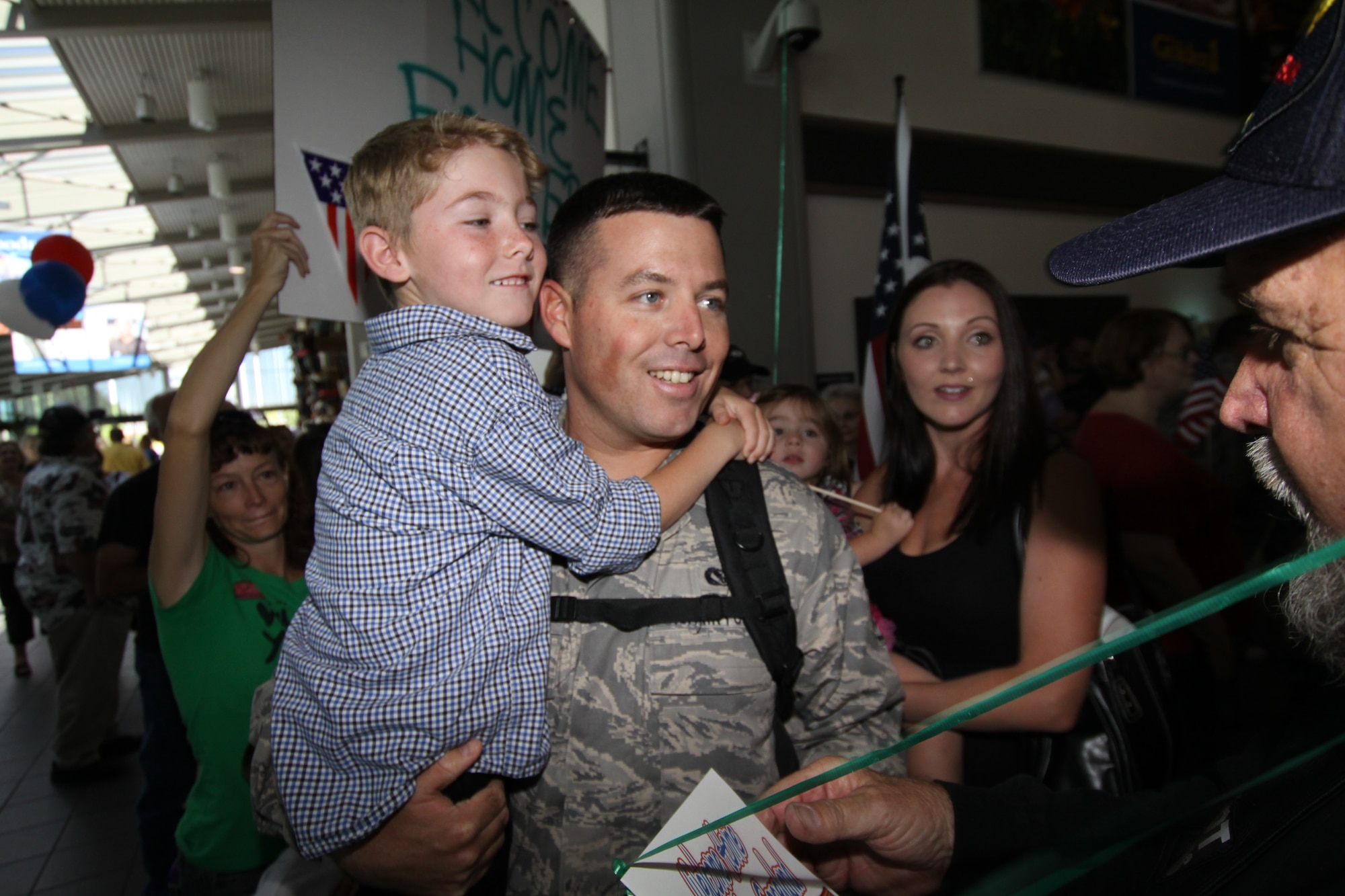 Staff Sgt.Scott Dozier, a Reservist with the 940th Civil Engineering Squadron, arrives home to a warm welcome from family, friends and fellow 940th Wing Reservists at the Sacramento International Airport, June 10, 2012. The Patriot Guard Riders were also on hand as Dozier and eight other 940 CES members from Beale Air Force Base,  returned to California from a 6-month deployment to Southwest Asia. (U.S. Air Force photo by Senior Master Sgt. Robert Pfenning)