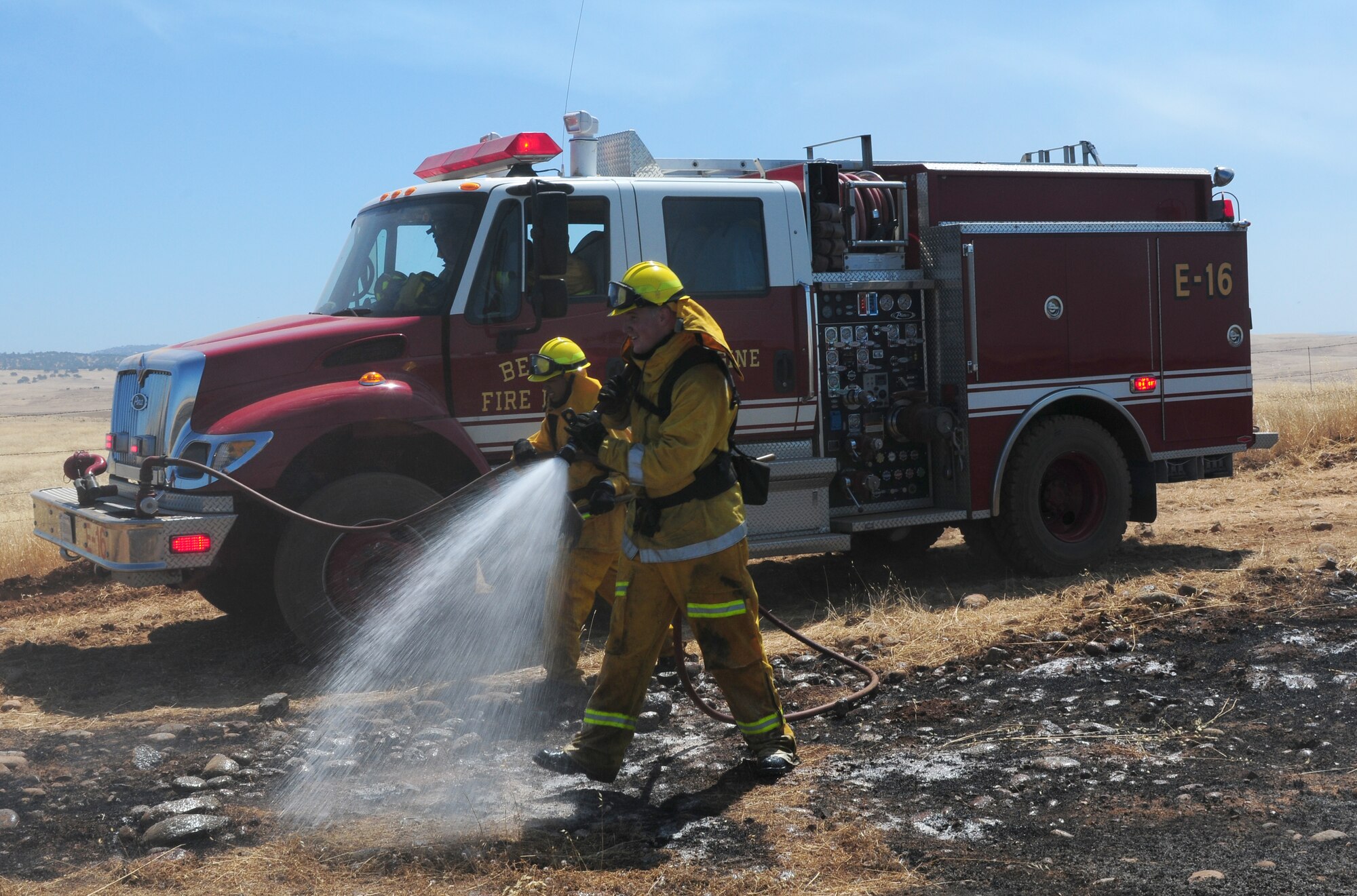 Airman 1st Class Dillon Johnson, 9th Civil Engineering Squadron firefighter, mans the hose on engine 16 during mop up duty at Beale Air Force Base, Calif., June 19, 2012. Team Beale firefighters perform mop up duty to prevent any ambers from spreading fire into other areas. (U.S. Air Force photo by Senior Airman Allen Pollard/Released)