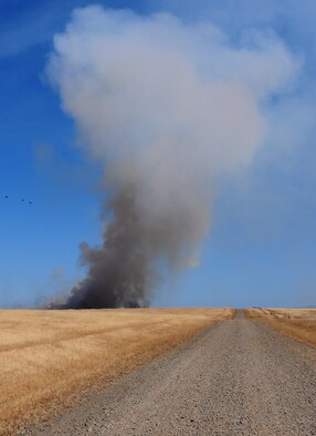 Smoke fills the sky from a prescribed burn at Beale Air Force Base, Calif., June 19. Team Beale firefighters burned the M60 machine gun range to prevent the field from catching on fire from hot casing during firing training. (U.S. Air Force photo by Senior Airman Allen Pollard/Released)