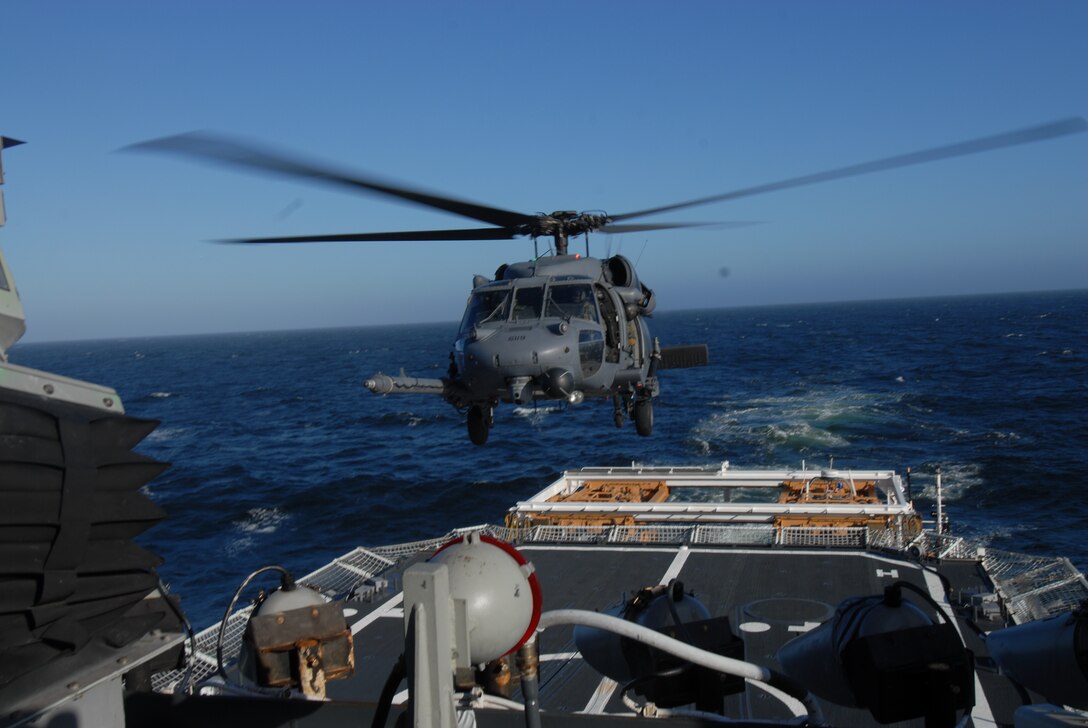 California Air National Guard members assigned to the 129th Rescue Squadron conduct aircraft deck landing qualifications with the United States Coast Guard, approximately 25 nautical miles off the coast of Northern California, June 20, 2012. This is the first landing of an Air Force HH-60G Pave Hawk on the National Security Coast Guard Cutter, USCG Bertholf. (Air National Guard photo by Staff Sgt. Kim E. Ramirez)