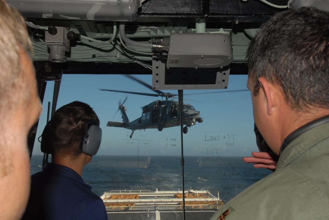 California Air National Guard members assigned to the 129th Rescue Squadron conduct aircraft deck landing qualifications with the United States Coast Guard, approximately 25 nautical miles off the coast of Northern California, June 20, 2012. This is the first landing of an Air Force HH-60G Pave Hawk on the National Security Coast Guard Cutter, USCG Bertholf. (Air National Guard photo by Staff Sgt. Kim E. Ramirez)