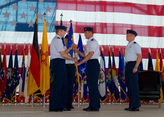 Colonel David Krumm, outgoing 49th Wing commander, relinquishes command of the 49th during the 49th WG change of command ceremony at Holloman Air Force Base, N.M. June 22. During Krumm's tour at Holloman AFB, he led the Wing in achieving an overall “Excellent” rating in an Operational Readiness Inspection, as well as having the best logistics readiness and force support squadrons in the Air Force. (U.S. Air Force Photo by Michael Shoemaker/Released)