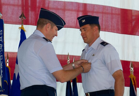 Lieutenant Gen. Robin Rand, 12th Air Force commander, pins the Legion of Merit Medal to Col. David Krumm, outgoing 49th Wing commander, during the 49th WG change of command ceremony at Holloman Air Force Base, N.M., June 22. Krumm was the first commander of the 49th WG after it changed from the 49th Fighter Wing in June of 2010. During his time here he helped deliver combat-ready F-22 airpower, and expanded the remotely piloted aircraft formal training unit more than 75 percent. (U.S. Air Force Photo by Airman 1st Class Michael Shoemaker/Released)