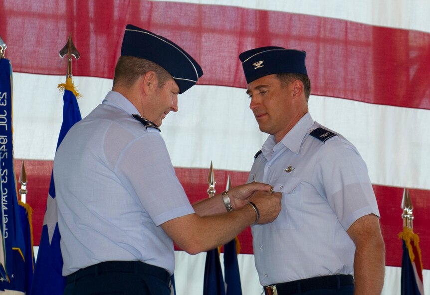 Lieutenant Gen. Robin Rand, 12th Air Force commander, pins the Legion of Merit Medal to Col. David Krumm, outgoing 49th Wing commander, during the 49th WG change of command ceremony at Holloman Air Force Base, N.M., June 22. Krumm was the first commander of the 49th WG after it changed from the 49th Fighter Wing in June of 2010. During his time here he helped deliver combat-ready F-22 airpower, and expanded the remotely piloted aircraft formal training unit more than 75 percent. (U.S. Air Force Photo by Airman 1st Class Michael Shoemaker/Released)