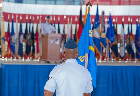 Airman 1st Class  Douglas Maina, Materiel Maintainance Support Squardon vehicle and vehicular equipment apprectice, stands in formation as the guidon bearer for the 49th Materiel Maintainance Group during the 49th Wing change of command ceremony at Holloman Air Force Base, N.M., June 22. All five groups under the 49th WG banner – 49th MMG, 49th Operations Group, 49th Maintenance Group, 49th Mission Support Group, and the 49th Medical Group – as well as the 46th Test Group and the German Air Force Flying Training Center were represented during the change of command ceremony. The change of command is a time-honored tradition that allows Airmen to witness the formal transfer of authority one commander to another.  (U.S. Air Force photo by Airman 1st Class Colin Cates/Released) 