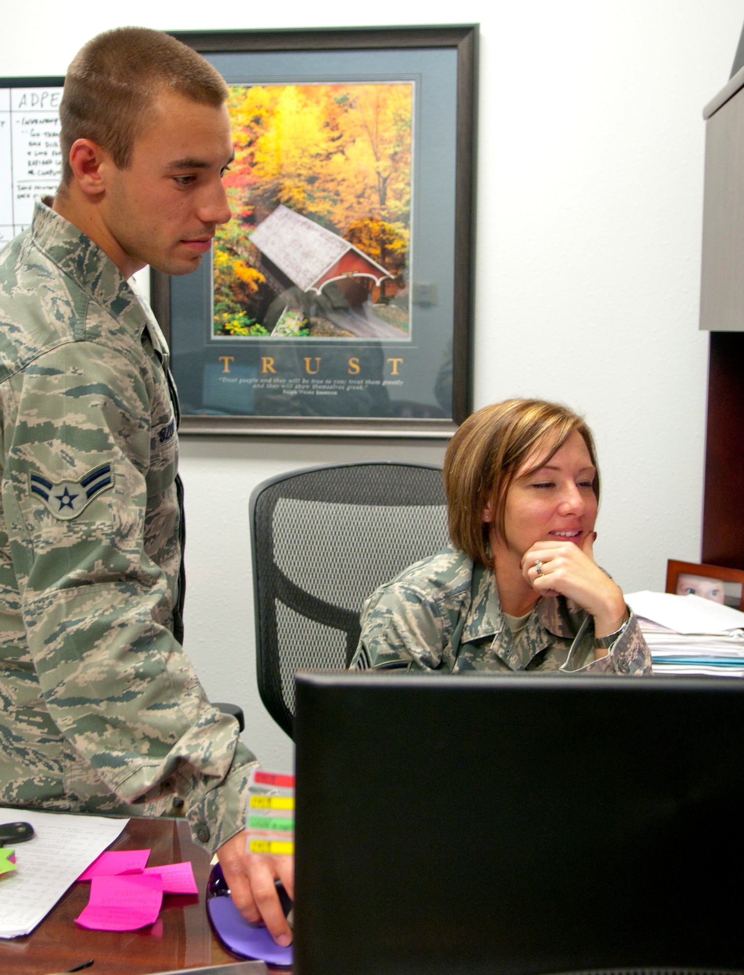 Airman 1st Class Cal Szur, 90th Communications Squadron client systems technician, explains a newly installed program to Staff Sgt. Erin Robinson, 20th Air Force knowledge operations manager, in the 20th AF Headquarters building  June 19. (U.S. Air Force Photo by Airman 1st Class Jason Wiese)