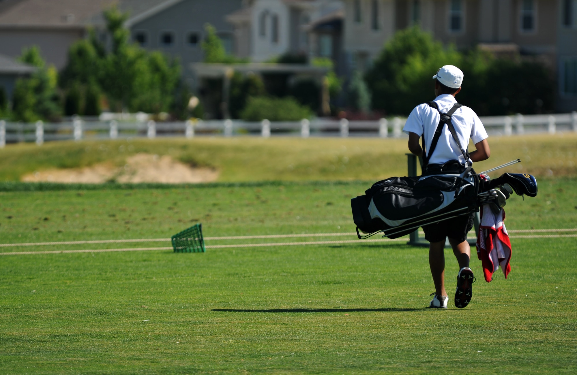 AURORA, Colo. — A local golfer heads out to the Murphy Creek Golf Course driving range to start his practice session June 19, 2012.  Murphy Creek has multiple sets of tees to play from in order to challenge golfers.  The golf course measures a total of 7,456 yards from the longest tees and has a U. S. Golf Association rating of 75.5.  This means that Murphy Creek plays three strokes harder than the average golf course.   (U.S. Air Force photo by Airman 1st Class Darryl Bolden Jr.)