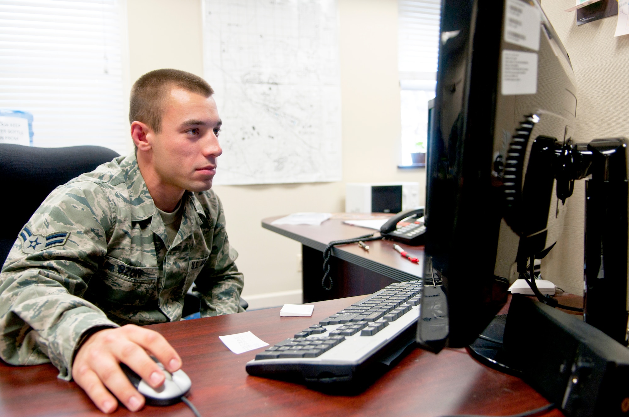 Airman 1st Class Cal Szur, 90th Communications Squadron client systems technician, remotely accesses computers on base to update their software in Building 333 June 18. He saves time by performing the updates remotely rather than updating them in person individually. (U.S. Air Force Photo by Airman 1st Class Jason Wiese)