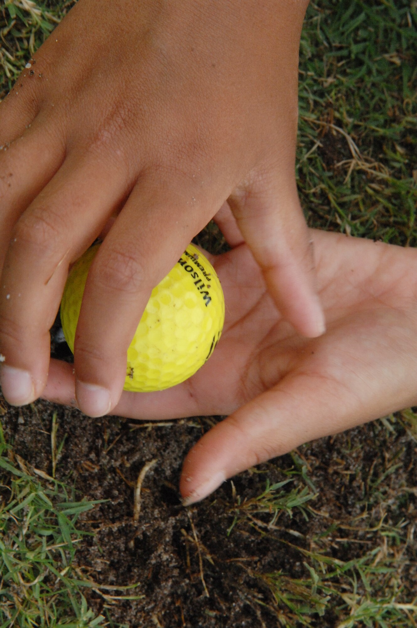 Mateya Sheppard places a ball on a tee during the Air Combat Command Kids’ golf program at the Carolina Lakes Golf Course, Shaw Air Force Base, S.C., June 20, 2012. This four-day class started on June 18. The class was organized by Katharine Williams, Carolina Lakes director of golf and former Professional Golf Association professional.(U.S. Air Force Airman Nicole Sikorski/Released)