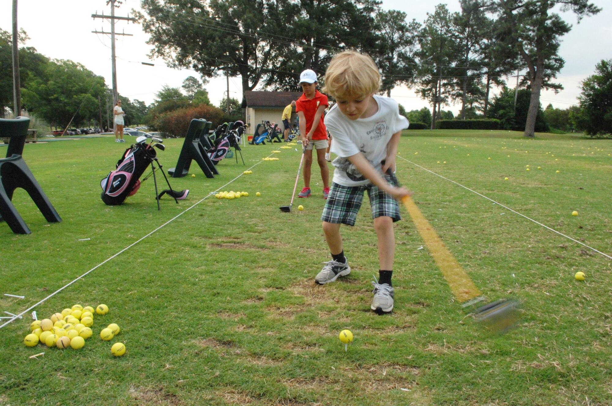 Jackson Murray drives a ball during the Air Combat Command Kids’ golf program, at the Carolina Lakes Golf Course, Shaw Air Force Base, S.C., June 20, 2012. This four-day class started on June 18. The class was organized by Katharine Williams, Carolina Lakes director of golf, and former Professional Golf Association professional.(U.S. Air Force Airman Nicole Sikorski/Released)
