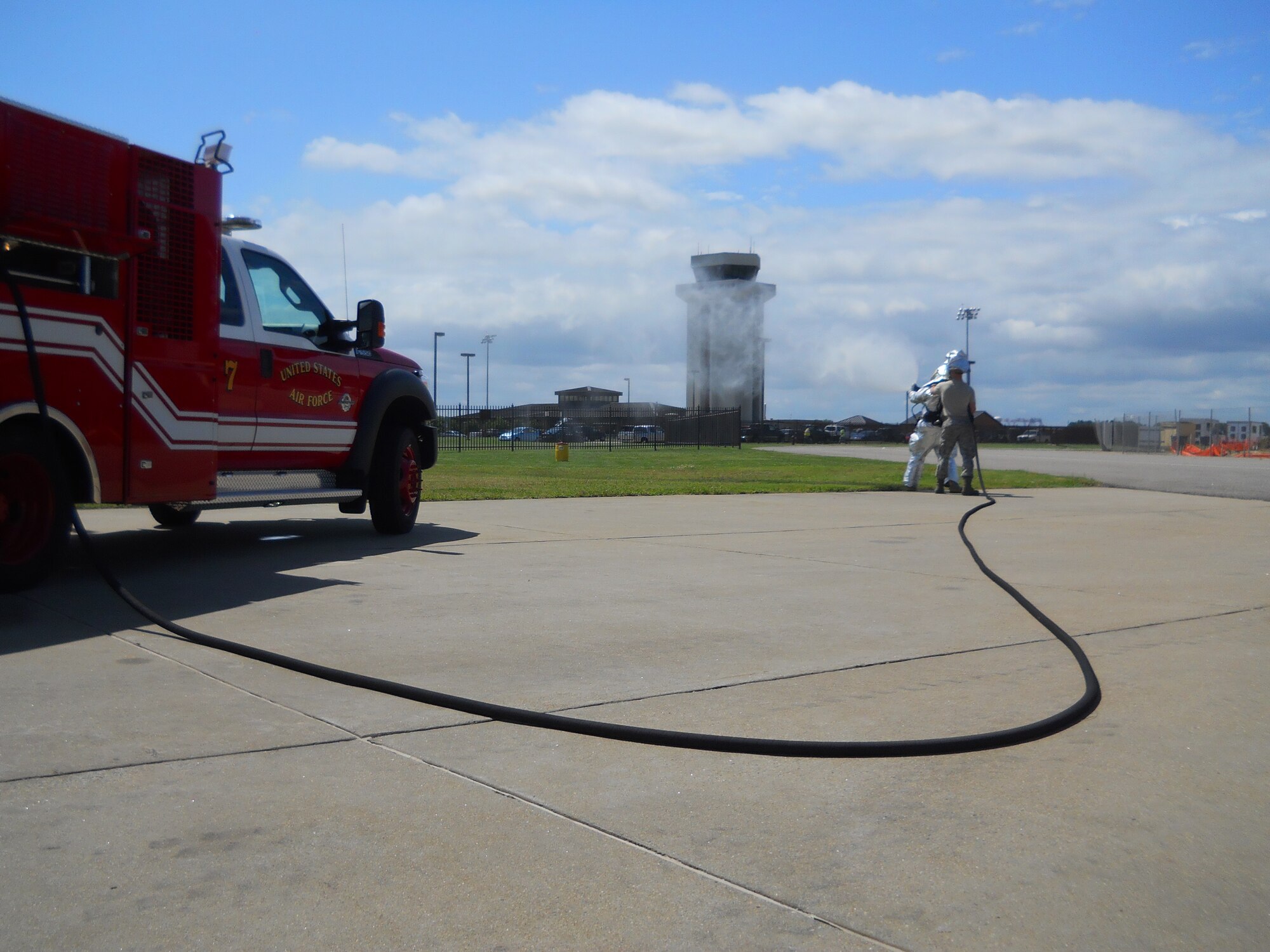 Airman Anthony Runco, 419th Fighter Wing firefighter, gets help from a colleague as he practices using an ultra-high-pressure firefighting system. (Courtesy photo)