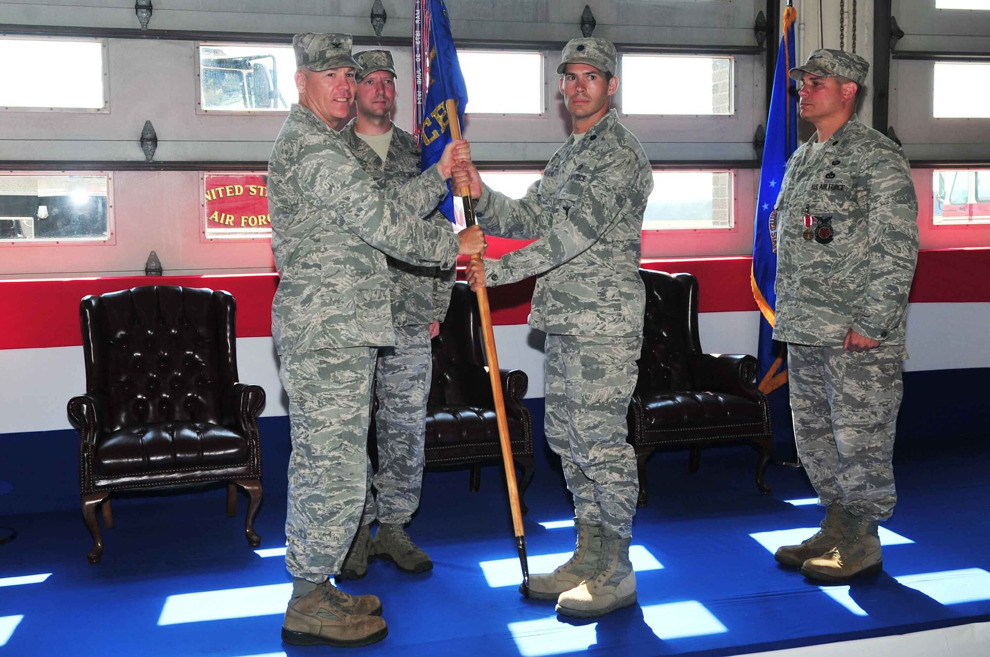 U.S. Air Force Col. Walter Fulda, 20th Mission Support group commander, passes the unit flag to Lt. Col. Terrence Walter, 20th Civil Engineering Squadron commander, Shaw Air Force Base, S.C. June 21, 2012.Changes of command are military tradition that represent the transfer of responsibilities from the presiding officials to the upcoming official. (U.S. Air Force photo by Airman 1st Class Ashley L. Gardner/ Released)

