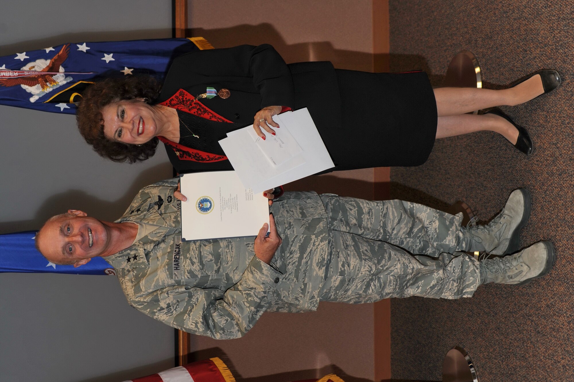KIRTLAND AFB, N.M. -- Maj. Gen. Garrett Harencak, Air Force Nuclear Weapons Center commander, recognizes Vita Kelley, AFNWC chief of the Development Division, Manpower and Personnel Directorate, Tuesday with a certificate commemorating 50 years of service to the Air Force. (Photo by Ken Moore)