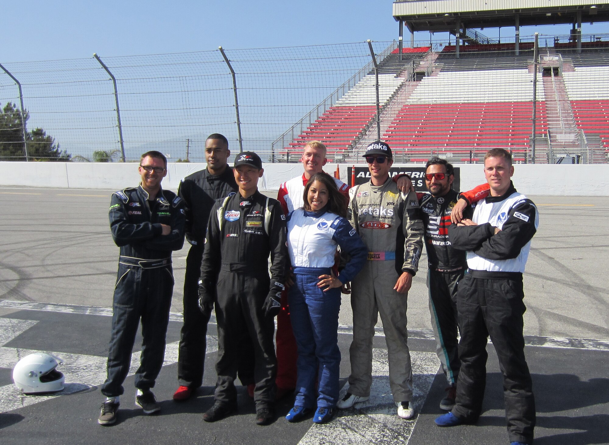 Airmen and professional drivers pose for a picture during the Drift into the Blue competition at Toyota Speedway in Irwindale, Calif. The competitions were judge according to execution and style, rather than who finished in the fastest time.
