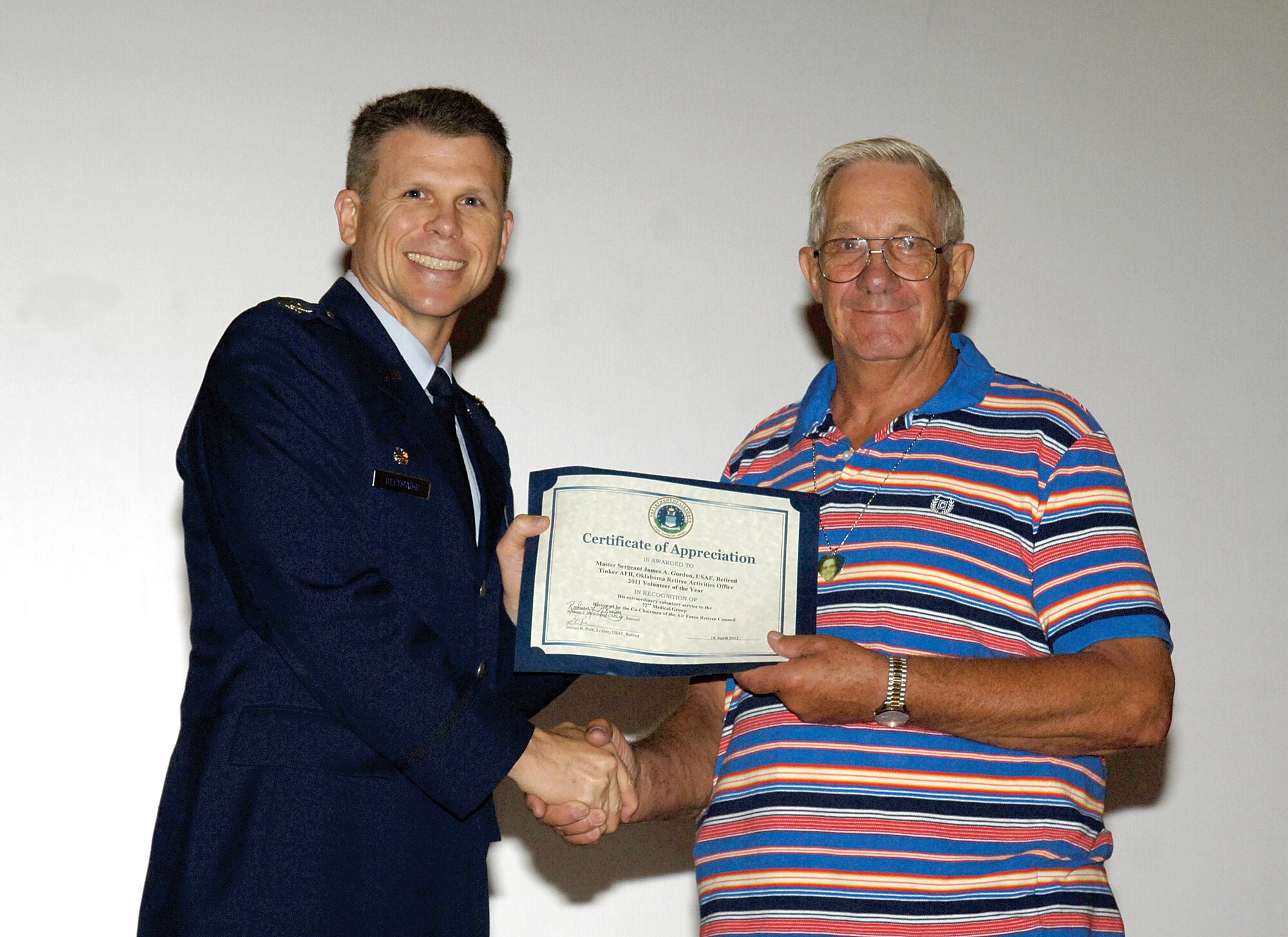 In thanks for his years of volunteer service, retired Air Force Master Sgt. James Gordon was named Volunteer of the Year and presented with a certificate June 15 by 72nd Air Base Wing and Tinker Installation Commander, Col. Steven Bleymaier.  For the last five years, Mr. Gordon has donated his time serving in the 72nd Medical Group four times a week. (Air Force photo by Margo Wright)
