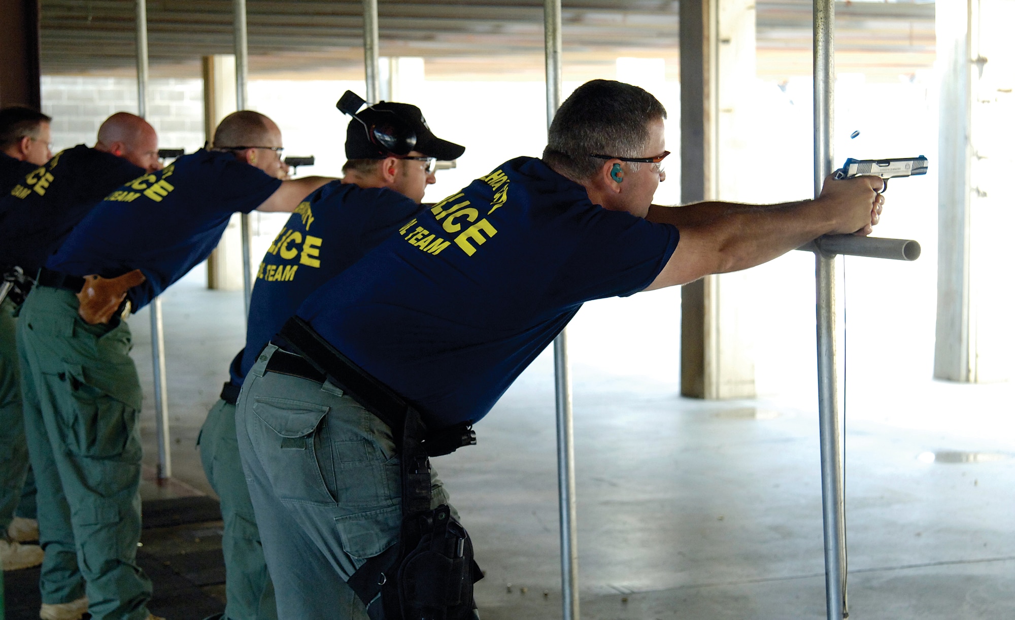 The Oklahoma City Police Department team fires at the Tinker Combat Arms range during the June 15 Pistol Competition between local, state and federal law enforcement agencies.  The OKCPD team earned first place during the annual event. (Air Force photo by Margo Wright)