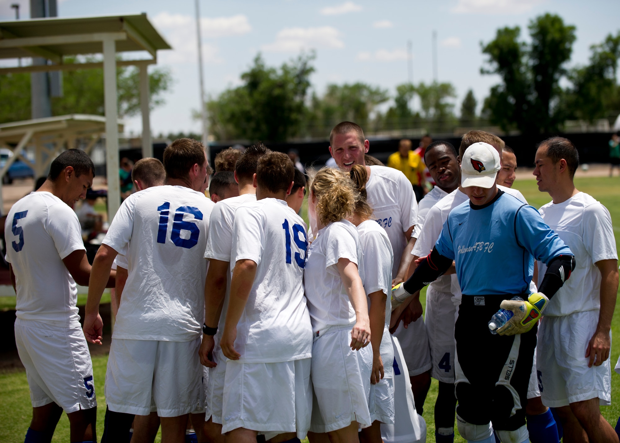 The Holloman Air Force Base, N.M., varsity soccer team huddles during half-time at Mayfield High School, Las Cruces, N.M., June 16. This season, the base soccer team excelled to the top of the Mesilla Valley Soccer League and won the championship game 4-2 for Team Holloman. The game was scoreless at half time, and the team used the huddle to re-group and re-focus for a stellar performance in the second half to win the game in overtime. (U.S. Air Force photo by Airman 1st Class Daniel E. Liddicoet/Released)