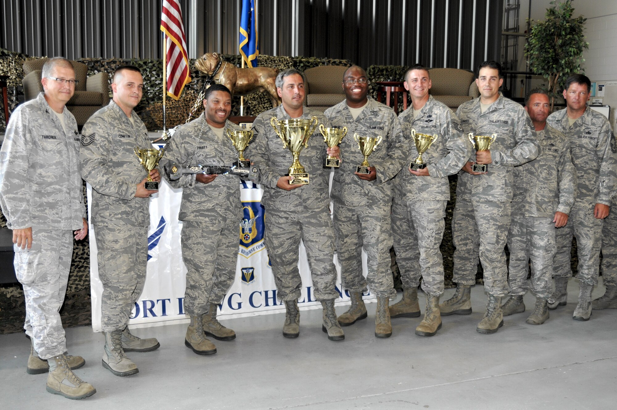 Col. Tim Tarchick (left), 94th Airlift Wing commander, Dobbins ARB, Ga, and host for the 2012 Port Dawg Challenge, presents the overall championship trophy to the 96th Aerial Port Squadron team of Tech. Sgt. Mark Compton, Tech. Sgt. Tobey Pruitt, Master Sgt. Clayton Crum, Tech. Sgt. Torreon Shirlee, Tech. Sgt. Morgan Abner and Tech. Sgt. Gustav Schmidle. (U.S. Air Force photo/Master Sgt. Chris Durney)