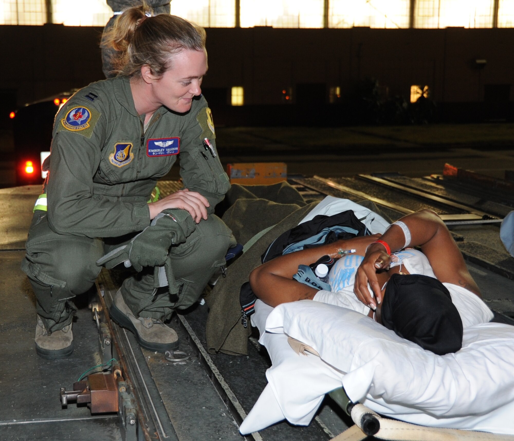JOINT BASE PEARL HARBOR-HICKAM, Hawaii – Capt. Kimberley Vaughan, 18th Medical Operations Squadron, checks on a patient during transfer from a KC-135 Stratotanker to an awaiting ambulance after an aeromedical evacuation flight here, June 21, 2012. Members of the active-duty Air Force and Reserve, Navy and Army worked together to ensure the safe passage of patients from the aeromedical evacuation flight to Tripler Army Medical Center in Honolulu. (U.S. Air Force photo/Staff Sgt. Lauren Padden)