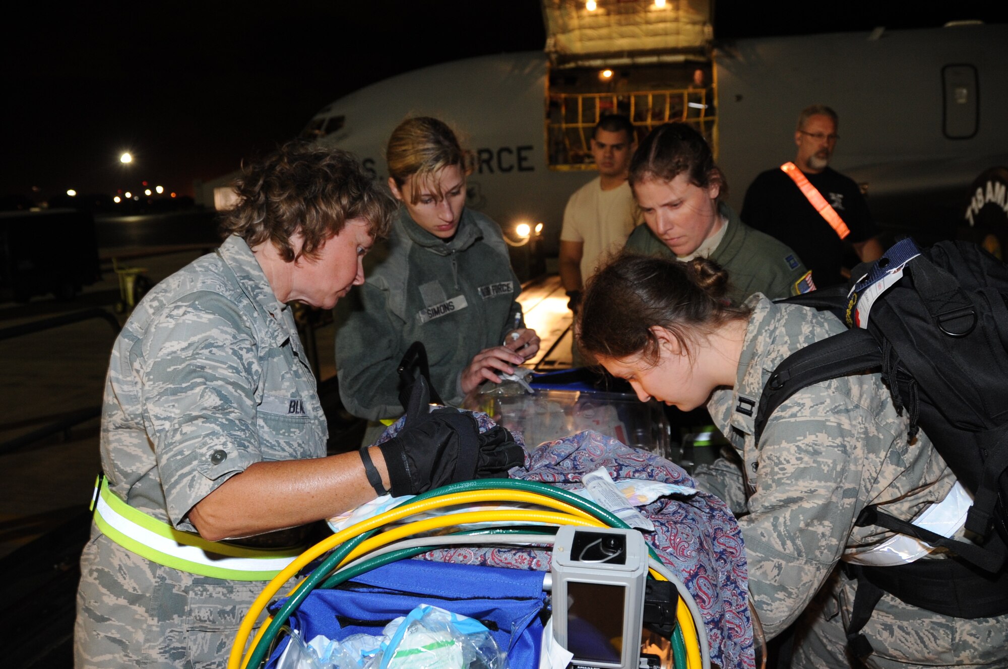 JOINT BASE PEARL HARBOR-HICKAM, Hawaii – Maj. Jill Blake, 442nd Medical Squadron medical administration flight commander, observes Capt. Rebekah Carlisle, 18th Medical Operations Squadron, flushing the line of an I.V. of an infant during transfer from an aeromedical evacuation flight to nearby Tripler Army Medical Center, June 21, 2012. Blake is on temporary duty working and training in various positions on the installation. The 442nd MDS is part of the 442nd Fighter Wing, an A-10 Thunderbolt II Air Force Reserve unit at Whiteman Air Force Base, Mo. (U.S. Air Force photo/Staff Sgt. Lauren Padden)