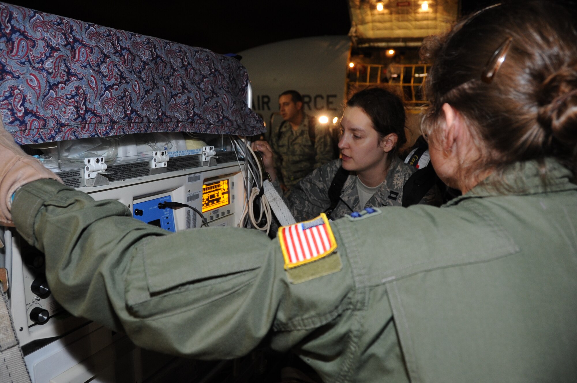 JOINT BASE PEARL HARBOR-HICKAM, Hawaii – Capt. Rebekah Carlisle, 18th Medical Operations Squadron, observes the vital signs of an infant during transfer from a KC-135 to an awaiting ambulance after an aeromedical evacuation flight here, June 21, 2012. Members of the active-duty Air Force and Reserve, Navy and Army worked together to ensure the safe passage of patients from the aeromedical evacuation flight to Tripler Army Medical Center in Honolulu. (U.S. Air Force photo/Staff Sgt. Lauren Padden)