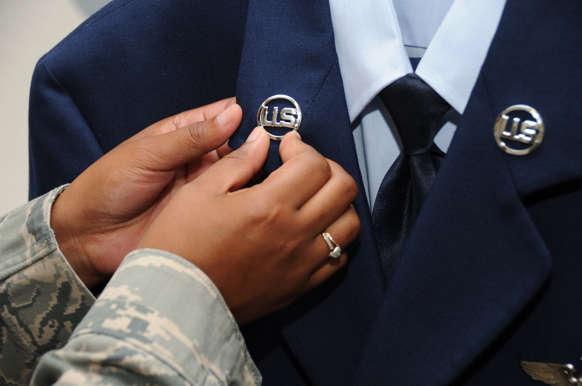 JOINT BASE PEARL HARBOR-HICKAM, Hawaii – Airman 1st Class Ciera Lawson, 442nd Force Support Squadron, adjusts the U.S. inisgnia on a uniform which will accompany the deceased remains of a veteran recovered from overseas, June 20, 2012. Lawson is on temporary duty working and training in various positions within the mortuary affairs office. The 442nd FSS is part of the 442nd Fighter Wing, an A-10 Thunderbolt II Reserve unit at Whiteman Air Force Base, Mo. (U.S. Air Force photo/Staff Sgt. Lauren Padden)