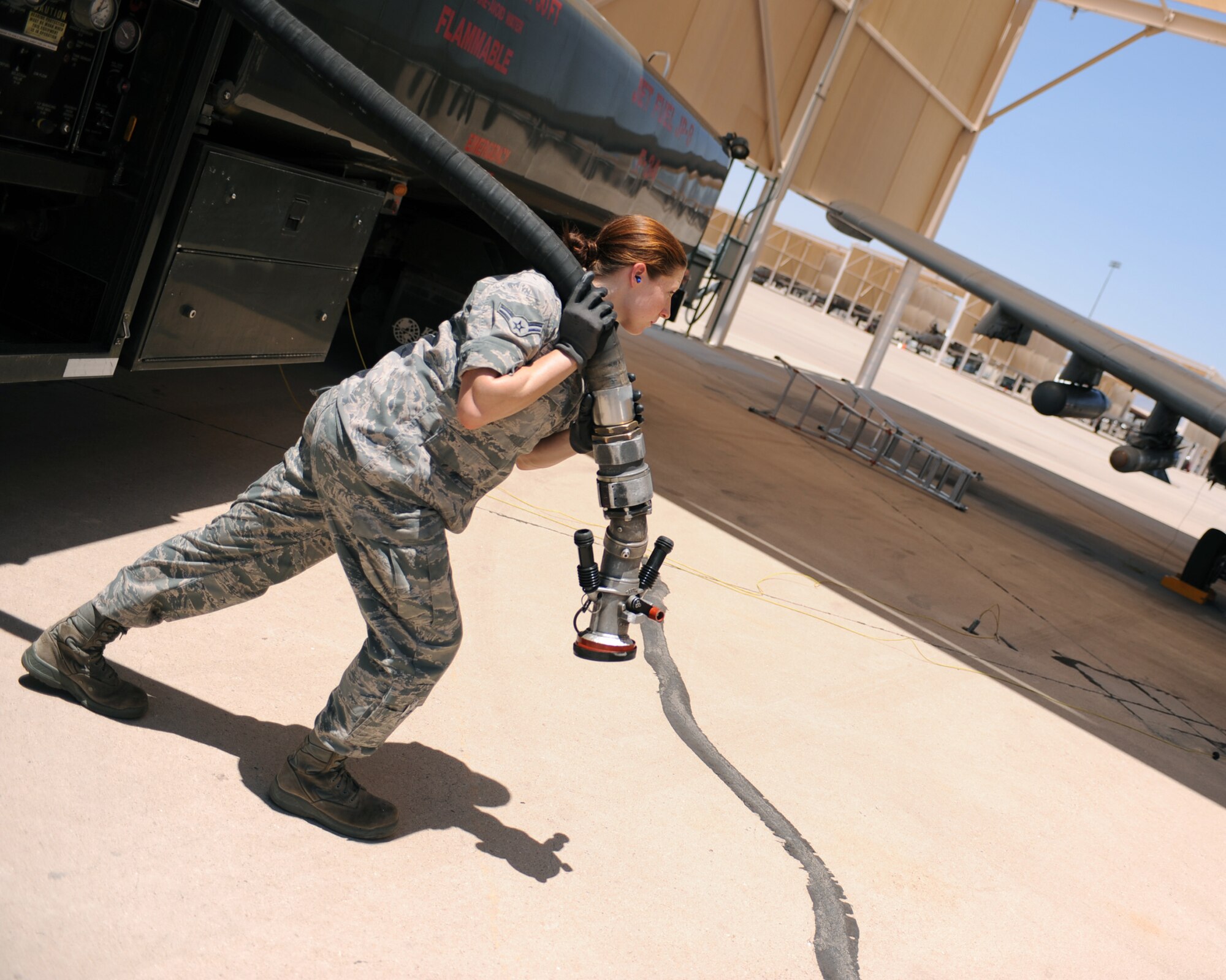 U.S. Air Force Airman 1st Class Kaitlin Carroll, 355th Logistics Readiness Squadron, unreels fueling hose prior to filling an A-10C aircraft on Davis-Monthan Air Force Base, Ariz., June 21, 2012. (U.S. Air Force photo by Airman 1st Class Christine Griffiths/Released) 