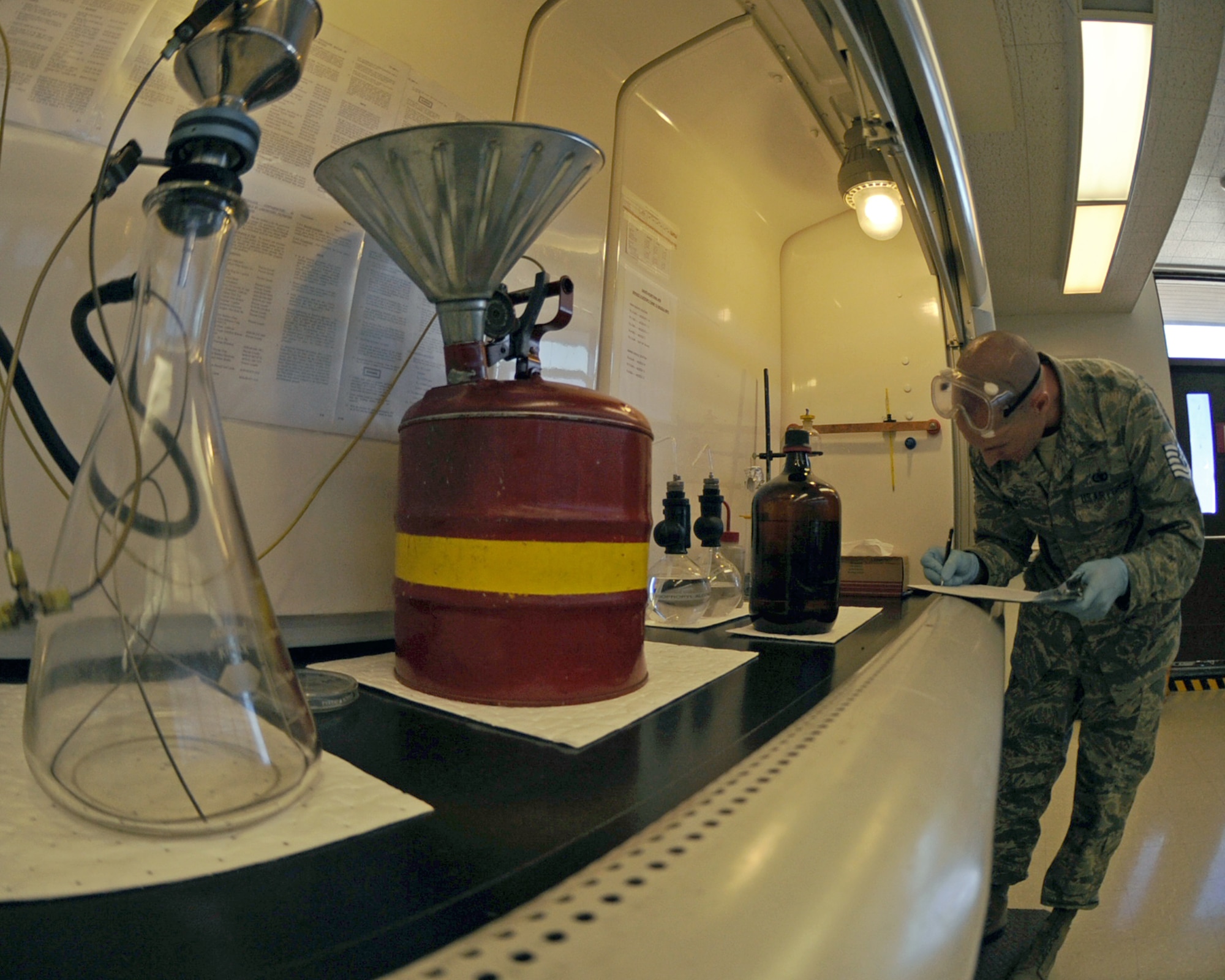 U.S. Air Force Tech. Sgt. Select Clark Twiss, 355th Logistics Readiness Squadron, records information prior to filtering a gasoline sample at the fuels lab on Davis-Monthan Air Force Base, Ariz., June 21, 2012. (U.S. Air Force photo by Airman 1st Class Christine Griffiths/Released) 