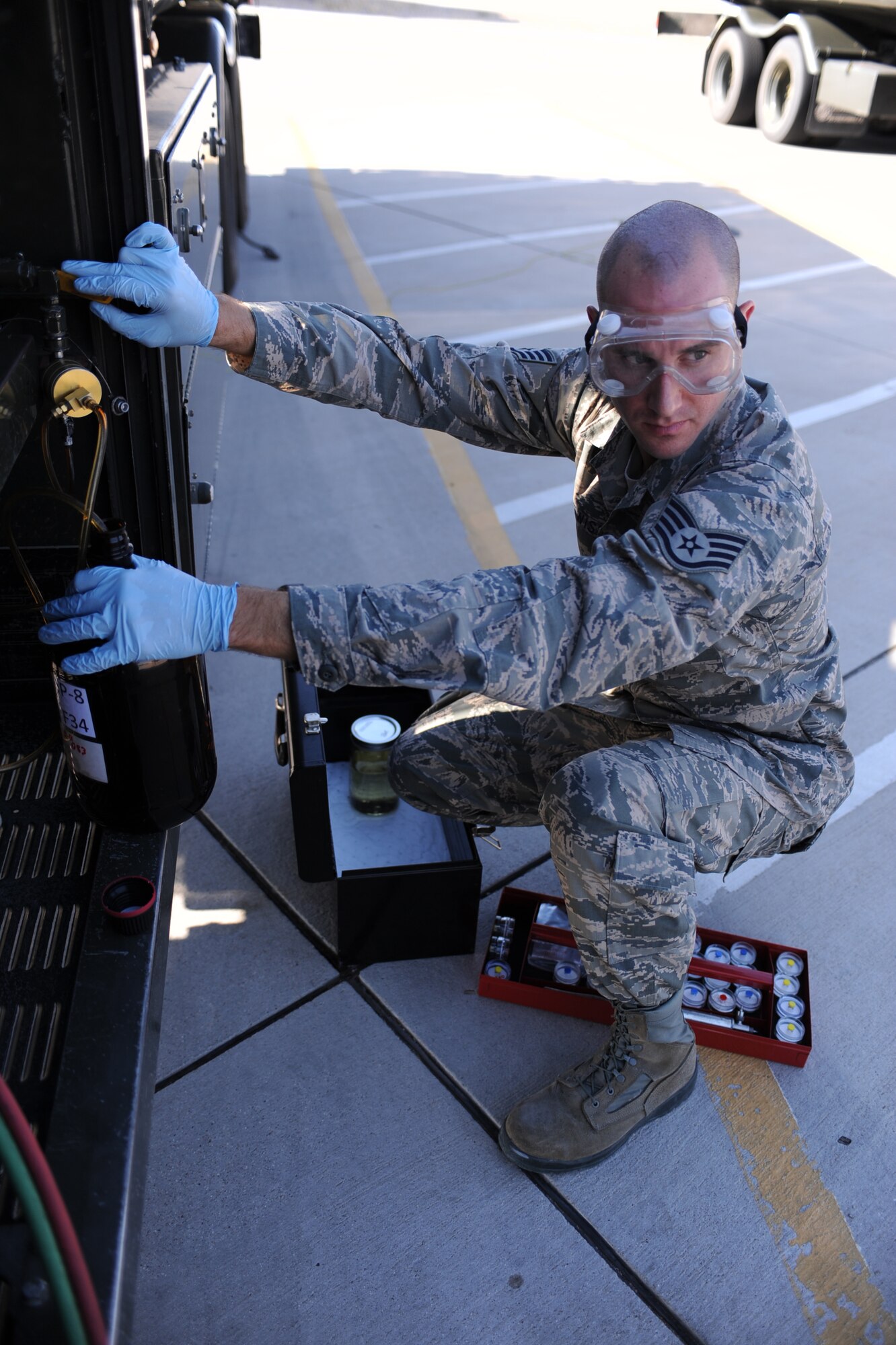 U.S. Air Force Tech. Sgt. Select Clark Twiss, 355th Logistics Readiness Squadron, takes a sample of gasoline from an R-11 fuel truck on Davis-Monthan Air Force Base, Ariz., June 21, 2012. Twiss will take the gasoline sample to conduct tests to determine the usability for the fuel. (U.S. Air Force photo by Airman 1st Class Christine Griffiths/Released) 