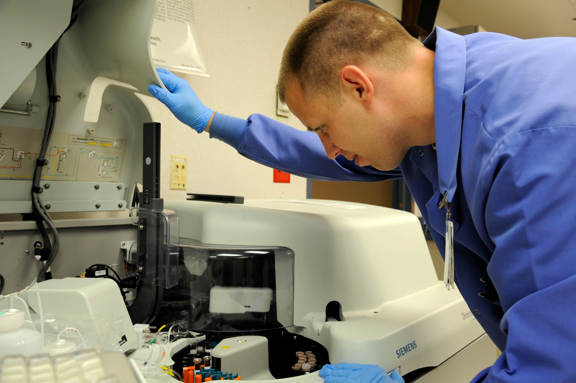 Staff Sgt. Steven Romel, 2nd Medical Support Squadron hematology NCO in charge, inspects and prepares blood samples for testing on Barksdale Air Force Base, La., June 19. The integrated chemistry machine tests the blood's content for the proper chemicals and blood cell count. (U.S. Air Force photo/Airman 1st Class Andrew Moua)(RELEASED)
