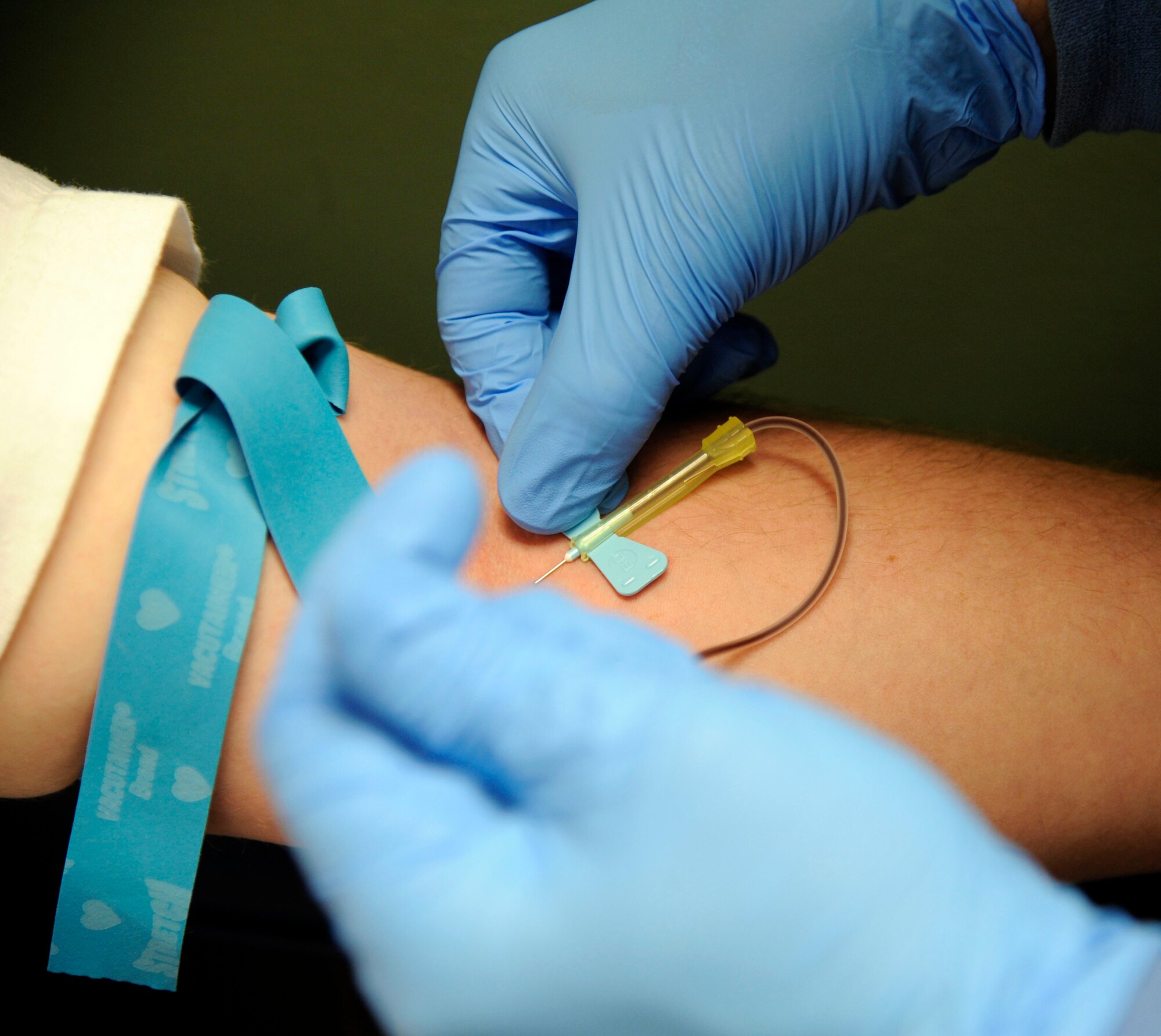 Staff Sgt. Steven Romel, 2nd Medical Support Squadron hematology NCO in charge, draws blood from a patient on Barksdale Air Force Base, La., June 19. Once the blood is drawn, it is sent through a centrifuge to seperate the blood's contents and tested to determine if there is anything abnormal with the patient.(U.S. Air Force photo/Airman 1st Class Andrew Moua)(RELEASED)